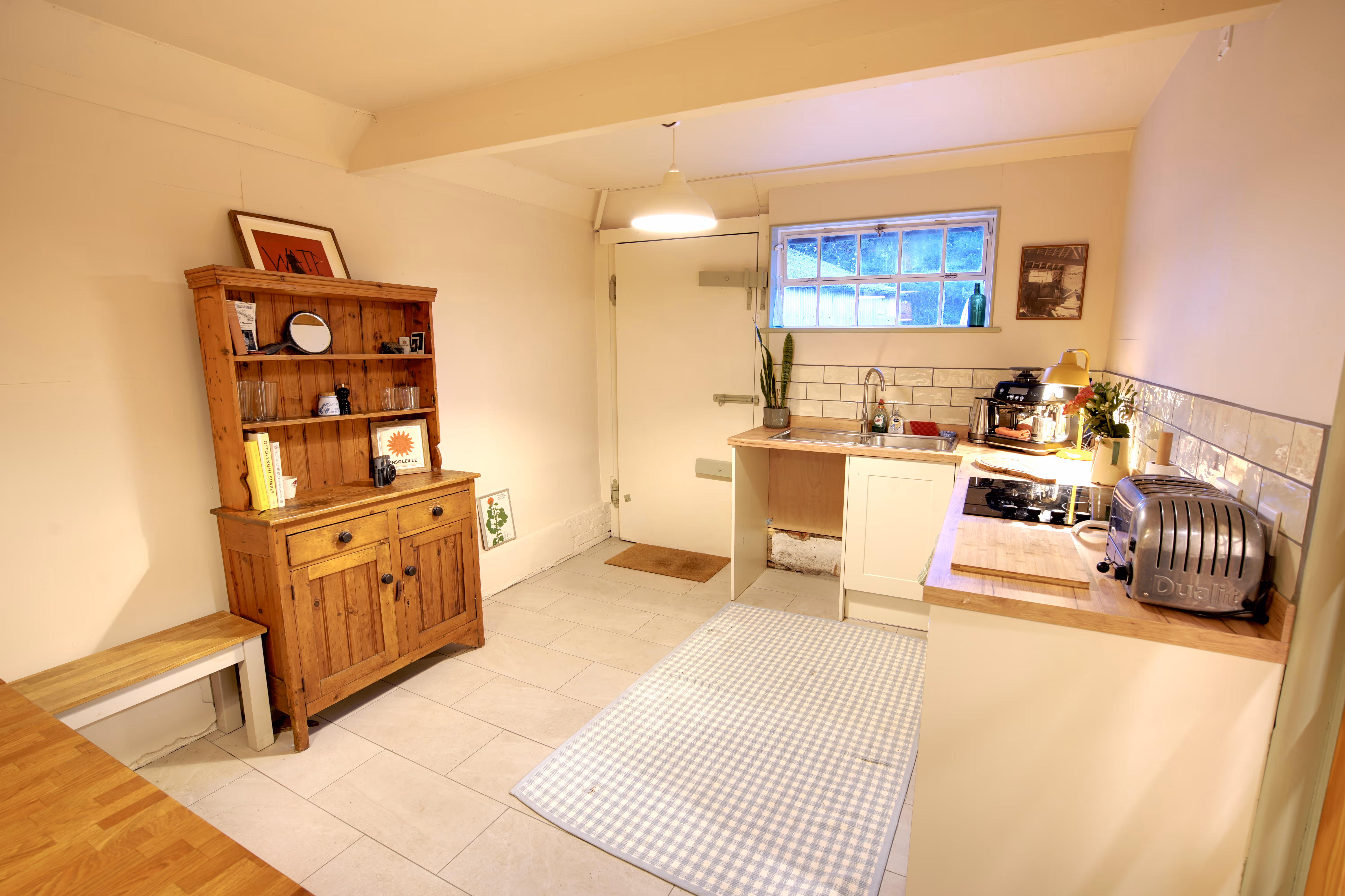 The kitchen — pine dresser, oak worktops, hob, Dualit toaster and espresso machine.